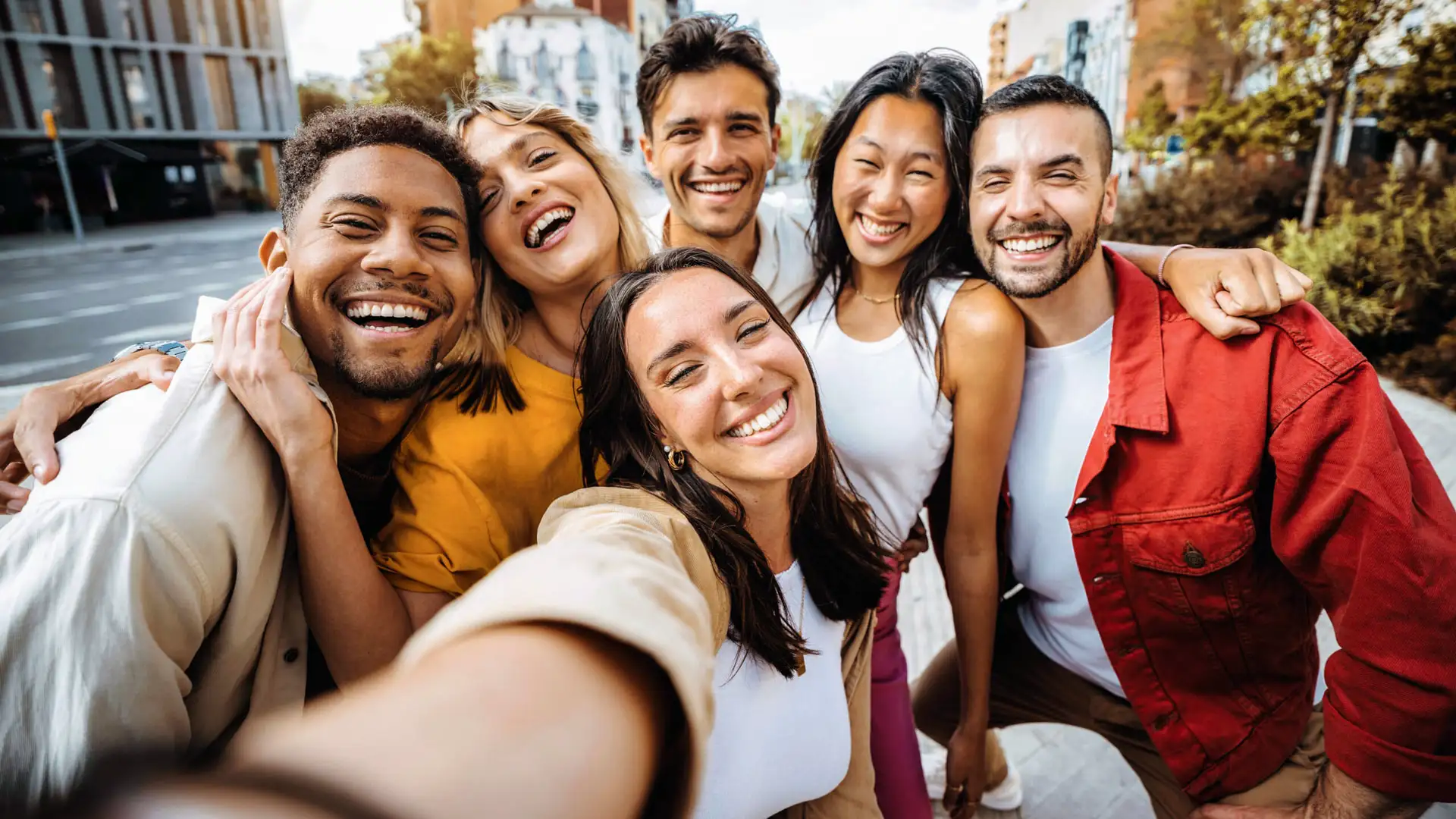 A group of friends smiling together for a selfie